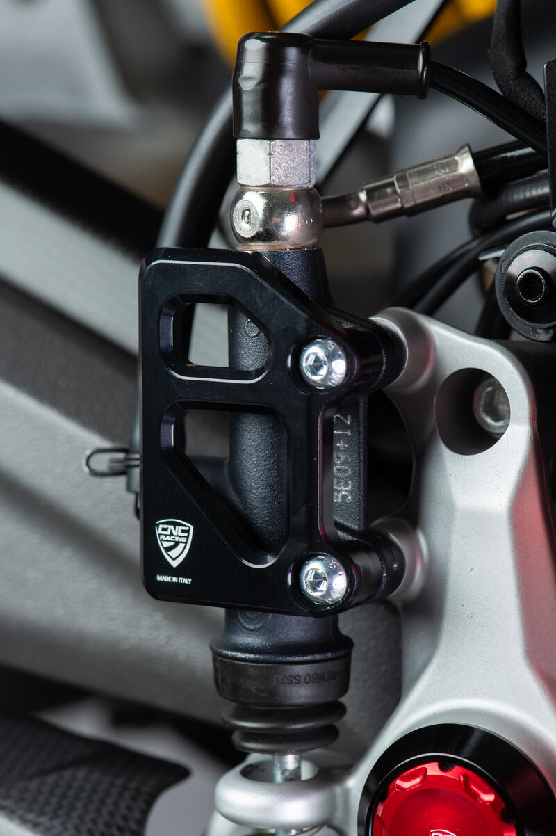 Rear brake master cylinder protector for factory rearsets